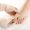Doctor with white gloves, takes in his hands subungual hematoma in the nail. Onycectomy, isolated background white. Close up.
